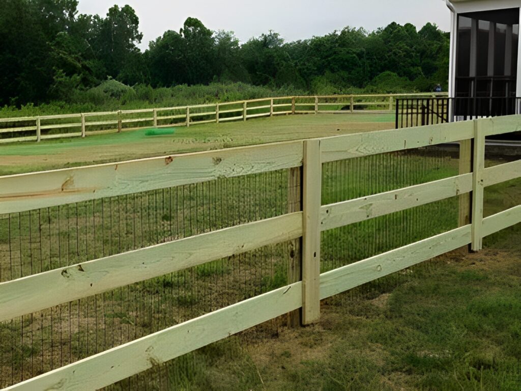 Wooden fence with greenery in the background.